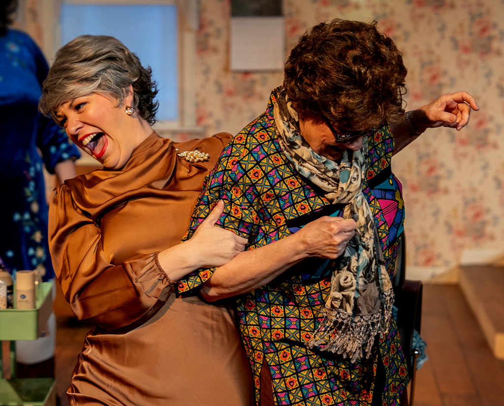 two characters laughing during a scene