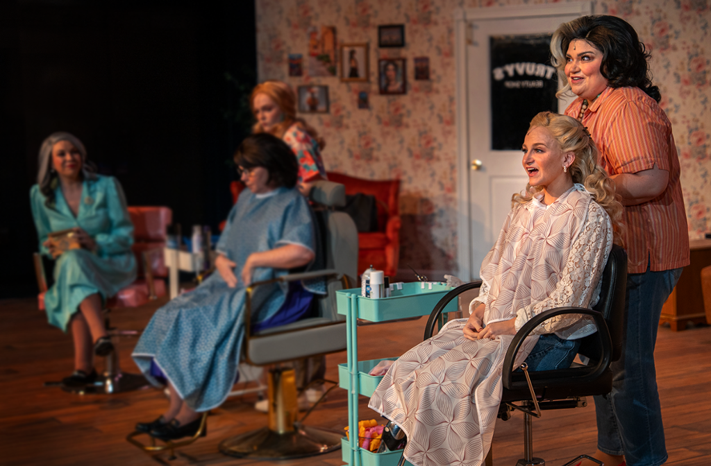 group of women sitting in chairs in a beauty shop