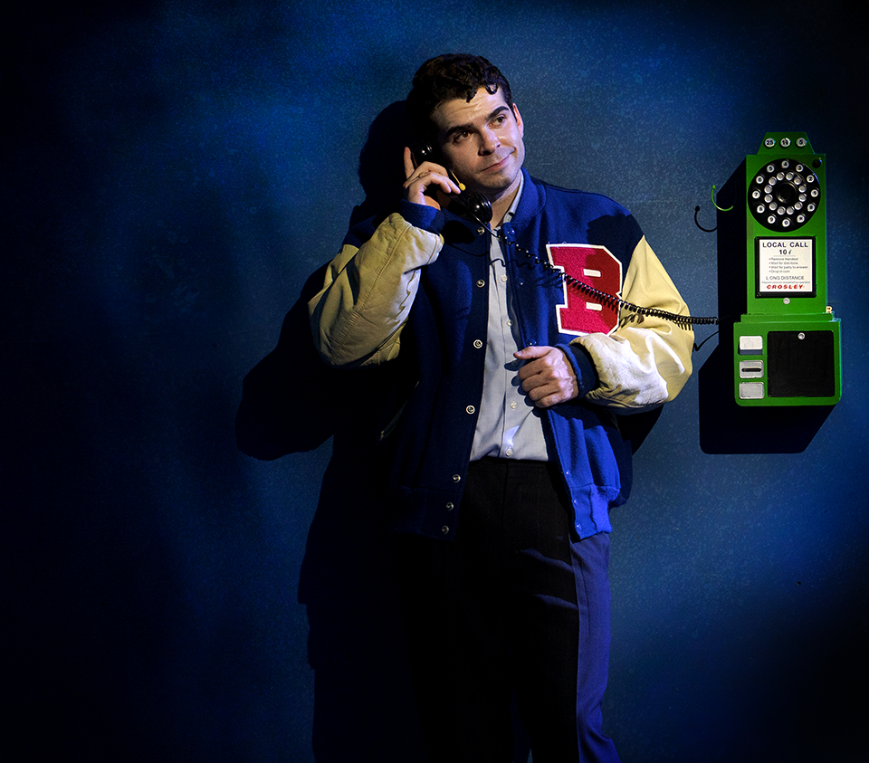 Frank Jr. on a pay phones smirking