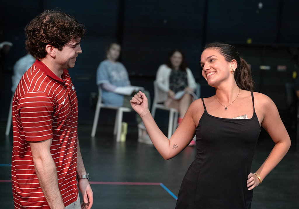 Actor and acress laughing in a scene
